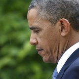 U.S. President Barack Obama listens to a question in the rain during a joint news conference with Turkish Prime Minister Recep Tayyip Erdoga