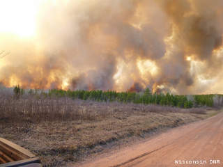 In this photo taken May 14, 2013 from Connors Meadow Road, The Germann Road Fire crowns through young red pine in Douglas County. (courtesy of the Wisconsin DNR). In this photo taken May 14, 2013 from Connors Meadow Road, The Germann Road Fire crowns through young red pine in Douglas County. (courtesy of the Wisconsin DNR).