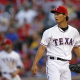 Texas Rangers starting pitcher Yu Darvish looks to the outfield after giving a hit to Detroit Tigers' Victor Martinez to score a run in the Texas Rangers starting pitcher Yu Darvish looks to the outfield after giving a hit to Detroit Tigers' Victor Martinez to score a run in the
