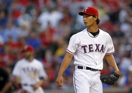 Texas Rangers starting pitcher Yu Darvish looks to the outfield after giving a hit to Detroit Tigers' Victor Martinez to score a run in the Texas Rangers starting pitcher Yu Darvish looks to the outfield after giving a hit to Detroit Tigers' Victor Martinez to score a run in the