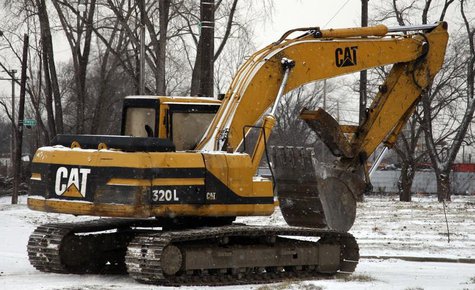 A Caterpillar excavator machine is seen at a work site in Detroit, Michigan January 25, 2013. REUTERS/ Rebecca Cook A Caterpillar excavator machine is seen at a work site in Detroit, Michigan January 25, 2013. REUTERS/ Rebecca Cook