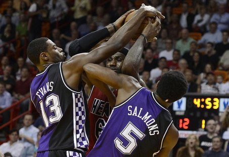Miami Heat's LeBron James (C) is defended by Sacramento Kings' Tyreke Evans and John Salmons (R) during the first half of their NBA basketba Miami Heat's LeBron James (C) is defended by Sacramento Kings' Tyreke Evans and John Salmons (R) during the first half of their NBA basketba