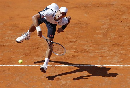 Novak Djokovic of Serbia serves to Tomas Berdych of Czech Republic during their men's singles quarter final match at the Rome Masters tennis Novak Djokovic of Serbia serves to Tomas Berdych of Czech Republic during their men's singles quarter final match at the Rome Masters tennis