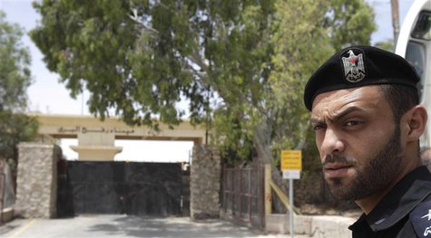 A member of Hamas security forces stands guard in front of the closed gate of the Rafah crossing with Egypt, in the southern Gaza Strip May A member of Hamas security forces stands guard in front of the closed gate of the Rafah crossing with Egypt, in the southern Gaza Strip May