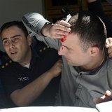 A policeman helps an injured man during clashes at an International Day Against Homophobia and Transphobia (IDAHO) rally in Tbilisi, May 17, A policeman helps an injured man during clashes at an International Day Against Homophobia and Transphobia (IDAHO) rally in Tbilisi, May 17,