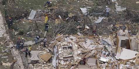 Rescue workers go through the debris of a house left flattened by a tornado in this aerial photograph taken over Granbury, Texas on May 16, Rescue workers go through the debris of a house left flattened by a tornado in this aerial photograph taken over Granbury, Texas on May 16,