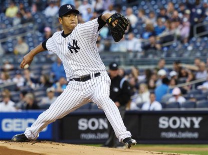 New York Yankees starting pitcher Hiroki Kuroda throws a pitch to the Toronto Blue Jays in the first inning of their MLB American League bas New York Yankees starting pitcher Hiroki Kuroda throws a pitch to the Toronto Blue Jays in the first inning of their MLB American League bas
