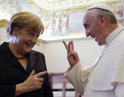Pope Francis (R) gestures as he talks to German Chancellor Angela Merkel during a private audience at the Vatican, May 18, 2013. REUTERS/Gre Pope Francis (R) gestures as he talks to German Chancellor Angela Merkel during a private audience at the Vatican, May 18, 2013. REUTERS/Gre