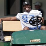 Injured Indianapolis Colts defensive end Dwight Freeney smiles as he drives a golf cart before practice at the Miami Dolphins training facil Injured Indianapolis Colts defensive end Dwight Freeney smiles as he drives a golf cart before practice at the Miami Dolphins training facil