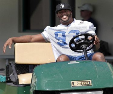Injured Indianapolis Colts defensive end Dwight Freeney smiles as he drives a golf cart before practice at the Miami Dolphins training facil Injured Indianapolis Colts defensive end Dwight Freeney smiles as he drives a golf cart before practice at the Miami Dolphins training facil