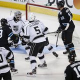 Members of the Los Angeles Kings and San Jose Sharks react as the game-winning puck shot by Sharks' Logan Couture (39) enters the goal in th Members of the Los Angeles Kings and San Jose Sharks react as the game-winning puck shot by Sharks' Logan Couture (39) enters the goal in th