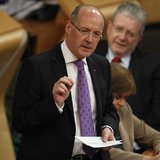 Scotland's Finance Secretary John Swinney gestures during his draft budget address in the debating chamber of the Scottish Parliament in Edi Scotland's Finance Secretary John Swinney gestures during his draft budget address in the debating chamber of the Scottish Parliament in Edi