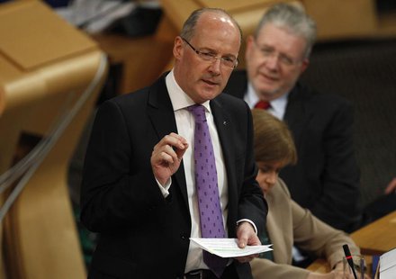 Scotland's Finance Secretary John Swinney gestures during his draft budget address in the debating chamber of the Scottish Parliament in Edi Scotland's Finance Secretary John Swinney gestures during his draft budget address in the debating chamber of the Scottish Parliament in Edi