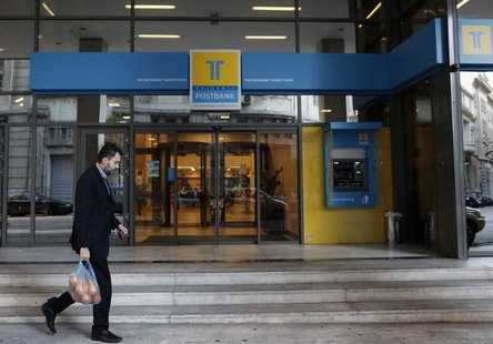 A man walks outside of the Hellenic Postbank's headquarters in Athens January 4, 2013. REUTERS/John Kolesidis A man walks outside of the Hellenic Postbank's headquarters in Athens January 4, 2013. REUTERS/John Kolesidis