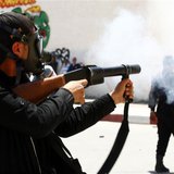 A police officer fires tear gas to break up a protest in the city of Kairouan May 19, 2013. REUTERS/Zoubeir Souissi A police officer fires tear gas to break up a protest in the city of Kairouan May 19, 2013. REUTERS/Zoubeir Souissi