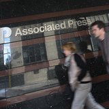 A couple walk past the offices of the Associated Press in Manhattan, New York May 13, 2013. REUTERS/Adrees Latif A couple walk past the offices of the Associated Press in Manhattan, New York May 13, 2013. REUTERS/Adrees Latif