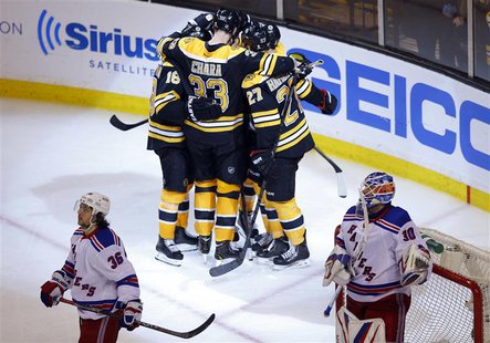 Boston Bruins' players celebrate after scoring against New York Rangers goaltender Henrik Lundqvist (R) and Rangers right wing Mats Zuccarel Boston Bruins' players celebrate after scoring against New York Rangers goaltender Henrik Lundqvist (R) and Rangers right wing Mats Zuccarel