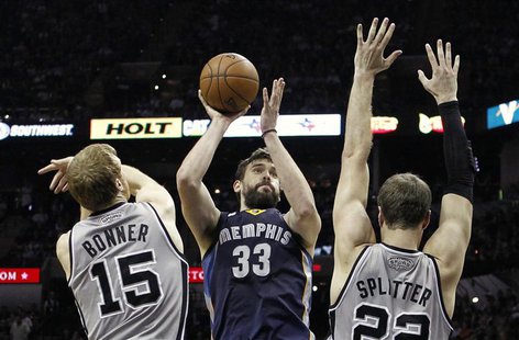 Memphis Grizzlies center Marc Gasol (C) shoots against San Antonio Spurs forward Matt Bonner (L) and center Tiago Splitter during the second Memphis Grizzlies center Marc Gasol (C) shoots against San Antonio Spurs forward Matt Bonner (L) and center Tiago Splitter during the second