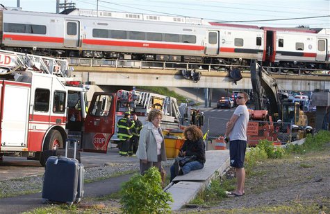 Passengers wait to be picked-up after two commuter trains collided in Bridgeport, Connecticut causing one to derail injuring numerous passen Passengers wait to be picked-up after two commuter trains collided in Bridgeport, Connecticut causing one to derail injuring numerous passen