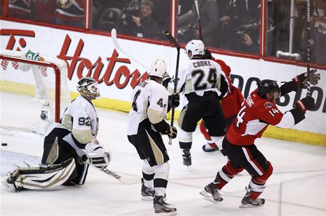 Ottawa Senators' Colin Greening (R) celebrates after scoring the game winning goal on Pittsburgh Penguins goalie Tomas Vokoun (L) during the Ottawa Senators' Colin Greening (R) celebrates after scoring the game winning goal on Pittsburgh Penguins goalie Tomas Vokoun (L) during the