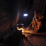 A woman cooks over a wood-burning fire under a battery-run emergency light during a power outage in a slum in Islamabad April 29, 2013. REUT A woman cooks over a wood-burning fire under a battery-run emergency light during a power outage in a slum in Islamabad April 29, 2013. REUT