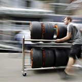 A Petronas mechanic pushes a trolley with Pirelli tires in the paddock ahead of the Spanish Formula One Grand Prix at the Circuit de Catalun A Petronas mechanic pushes a trolley with Pirelli tires in the paddock ahead of the Spanish Formula One Grand Prix at the Circuit de Catalun