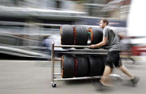 A Petronas mechanic pushes a trolley with Pirelli tires in the paddock ahead of the Spanish Formula One Grand Prix at the Circuit de Catalun A Petronas mechanic pushes a trolley with Pirelli tires in the paddock ahead of the Spanish Formula One Grand Prix at the Circuit de Catalun
