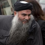 Radical Muslim cleric Abu Qatada is seen arriving back at his home after being released on bail, in London in this November 13, 2012 file ph Radical Muslim cleric Abu Qatada is seen arriving back at his home after being released on bail, in London in this November 13, 2012 file ph
