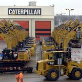 Workers walk past Caterpillar excavator machines at a factory in Gosselies February 28, 2013. REUTERS/Eric Vidal Workers walk past Caterpillar excavator machines at a factory in Gosselies February 28, 2013. REUTERS/Eric Vidal