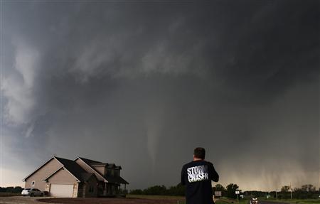 Storm chaser videographer and photographer Brad Mack records a tornado near a home in South Haven, in Kansas May 19, 2013.
REUTERS/Gene Blevins Storm chaser videographer and photographer Brad Mack records a tornado near a home in South Haven, in Kansas May 19, 2013.
REUTERS/Gene Blevins