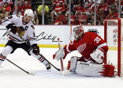 Detroit Red Wings goalie Jimmy Howard (35) makes a save on Chicago Blackhawks center Jonathan Toews (19) in the 2nd period of Game 3 of thei Detroit Red Wings goalie Jimmy Howard (35) makes a save on Chicago Blackhawks center Jonathan Toews (19) in the 2nd period of Game 3 of thei