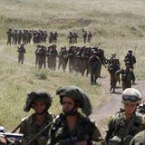 Israeli soldiers walk together during a training close to the ceasefire line between Israel and Syria on the Israeli occupied Golan Heights Israeli soldiers walk together during a training close to the ceasefire line between Israel and Syria on the Israeli occupied Golan Heights