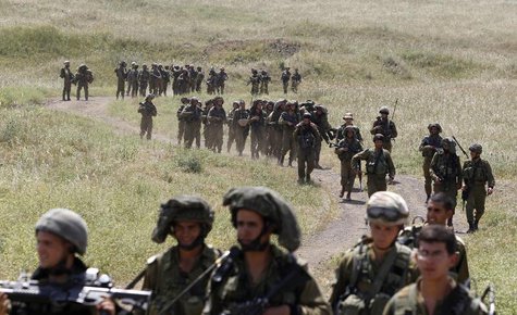 Israeli soldiers walk together during a training close to the ceasefire line between Israel and Syria on the Israeli occupied Golan Heights Israeli soldiers walk together during a training close to the ceasefire line between Israel and Syria on the Israeli occupied Golan Heights