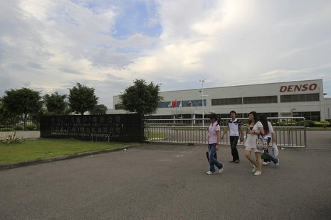 Employees walk outside of the Denso (Guangzhou Nansha) Co Ltd plant in Nansha, Guangdong province June 22, 2010. REUTERS/Tyrone Siu Employees walk outside of the Denso (Guangzhou Nansha) Co Ltd plant in Nansha, Guangdong province June 22, 2010. REUTERS/Tyrone Siu