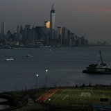 People play soccer on a pitch on the banks of the Hudson River in front of the New York City skyline as seen from Weehawken, New Jersey, Apr People play soccer on a pitch on the banks of the Hudson River in front of the New York City skyline as seen from Weehawken, New Jersey, Apr