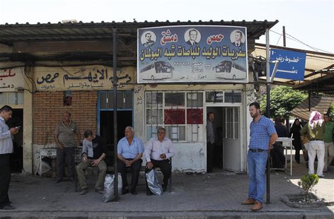 People wait for buses at the al-Abassin bus station, near Damascus' Jobar neighbourhood which is controlled by the Islamist Syrian rebel gro People wait for buses at the al-Abassin bus station, near Damascus' Jobar neighbourhood which is controlled by the Islamist Syrian rebel gro