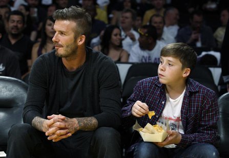 Soccer star David Beckham (L) and his son Brooklyn watch the Los Angeles Lakers play the Denver Nuggets during Game 1 of their first round N Soccer star David Beckham (L) and his son Brooklyn watch the Los Angeles Lakers play the Denver Nuggets during Game 1 of their first round N