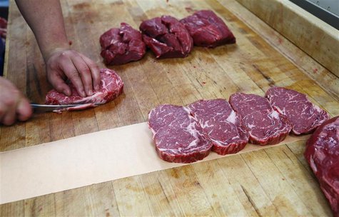 Clayton Colliou, a meat cutter at Bon Ton Meat Market, cuts choice cuts of Alberta beef in Calgary, Alberta in this October 3, 2012 file pho Clayton Colliou, a meat cutter at Bon Ton Meat Market, cuts choice cuts of Alberta beef in Calgary, Alberta in this October 3, 2012 file pho