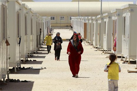 Syrian refugees walk inside the Mrajeeb Al Fhood refugee camp, 20 km (12.4 miles) east of the city of Zarqa April 29, 2013. REUTERS/Muhammad Syrian refugees walk inside the Mrajeeb Al Fhood refugee camp, 20 km (12.4 miles) east of the city of Zarqa April 29, 2013. REUTERS/Muhammad