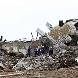 Rescue workers look through the rubble at Plaza Towers Elementary school in Moore, Oklahoma May 21, 2013 after a devastating tornado ripped Rescue workers look through the rubble at Plaza Towers Elementary school in Moore, Oklahoma May 21, 2013 after a devastating tornado ripped