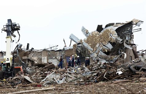 Rescue workers look through the rubble at Plaza Towers Elementary school in Moore, Oklahoma May 21, 2013 after a devastating tornado ripped Rescue workers look through the rubble at Plaza Towers Elementary school in Moore, Oklahoma May 21, 2013 after a devastating tornado ripped