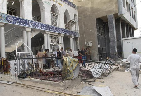 Onlookers gather outside Zain al-Abideen mosque, a Shiite place of worship, to inspect damage a day after a suicide bomb attack in Hilla, 10 Onlookers gather outside Zain al-Abideen mosque, a Shiite place of worship, to inspect damage a day after a suicide bomb attack in Hilla, 10