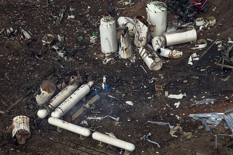 Investigators stand amid the aftermath of a massive explosion at a fertilizer plant in the town of West, near Waco, Texas April 18, 2013. RE Investigators stand amid the aftermath of a massive explosion at a fertilizer plant in the town of West, near Waco, Texas April 18, 2013. RE