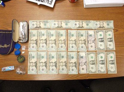 Cash, drugs, and liquor were seized in the traffic stop. Cash, drugs, and liquor were seized in the traffic stop.