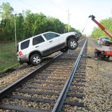 The vehicle had to be removed after becoming stuck on the railroad tracks.