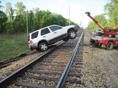 The vehicle had to be removed after becoming stuck on the railroad tracks. The vehicle had to be removed after becoming stuck on the railroad tracks.
