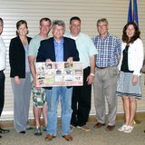 Outgoing Zeeland School Board member David Lutz (holding poster) is honored by his colleagues at his final board meeting on May 20, 2013. (photo courtesy Zeeland Public Schools)