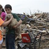 Abby Madi (L) and Peterson Zatterlee comforts Zaterlee's dog Rippy, after a tornado struck Moore, Oklahoma, May 20, 2013. 
REUTERS/Gene Blevins