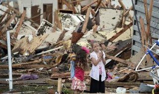 Two girls stand in rubble after a tornado struck Moore, Oklahoma, May 20, 2013. 
REUTERS/Gene Blevins