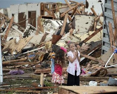 Two girls stand in rubble after a tornado struck Moore, Oklahoma, May 20, 2013.
REUTERS/Gene Blevins Two girls stand in rubble after a tornado struck Moore, Oklahoma, May 20, 2013.
REUTERS/Gene Blevins
